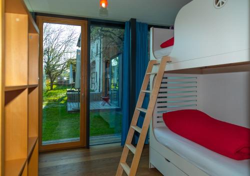 a bunk bed in a small room with a ladder at Zeitraumferien in Bernau am Chiemsee