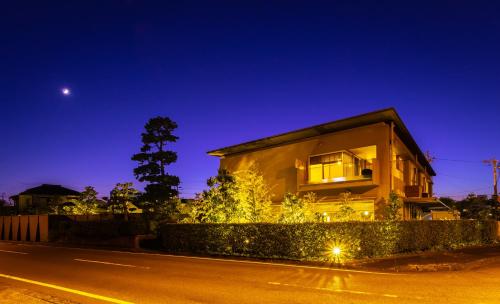a house on the side of a street at night at Migiwaya in Yaizu