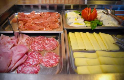 a display of different types of meats and cheese at Hotel Janeiro in Caorle