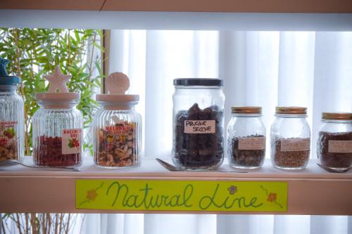 a shelf with jars filled with different types of food at Hotel Janeiro in Caorle