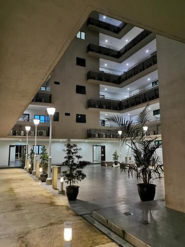 an empty lobby with potted plants in a building at Bernard Holiday Home 2 @ Boulevard Imperial Suite Kuching in Kuching