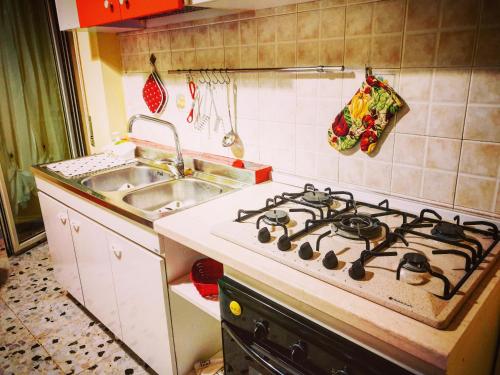 a kitchen with a stove top oven next to a sink at Central Isernia in Isernia