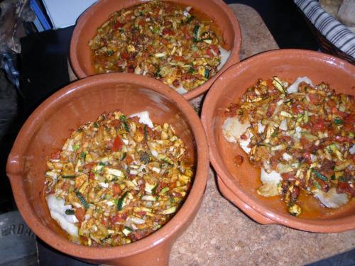 two dishes of food sitting on a table at Unique Tiny House with Natural Building Techniques in Figueiró dos Vinhos