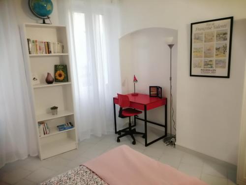 a bedroom with a red desk and a red table at LE PETIT VENTOUX VILLAGE in Malaucène