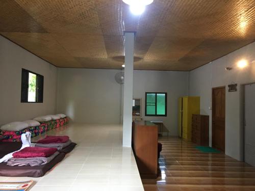 a room with beds and a table in it at Thong Family Homestay Chiangdao in Chiang Dao