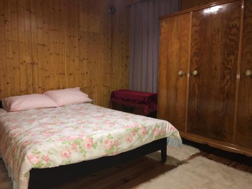 a bedroom with a bed and a wooden cabinet at Ioannina Traditional House in Ioannina