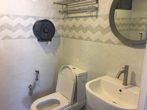 a bathroom with a toilet and a sink at The View Feringghi Executive Apartment in Batu Ferringhi