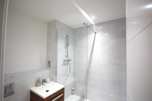 a bathroom with a shower and a toilet and a sink at Luxury Birmingham City Centre Apartment in Birmingham