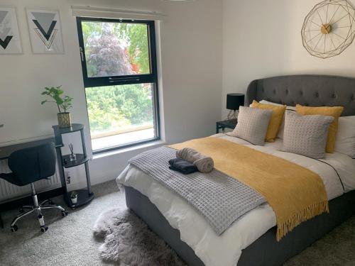 a bedroom with a large bed and a window at Luxury Birmingham City Centre Apartment in Birmingham