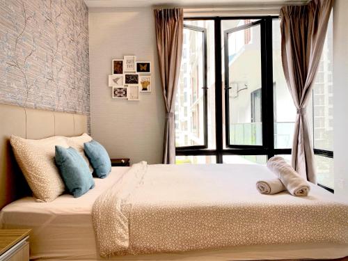 a bedroom with a bed and a large window at The Lakes at Midhills Genting in Genting Highlands