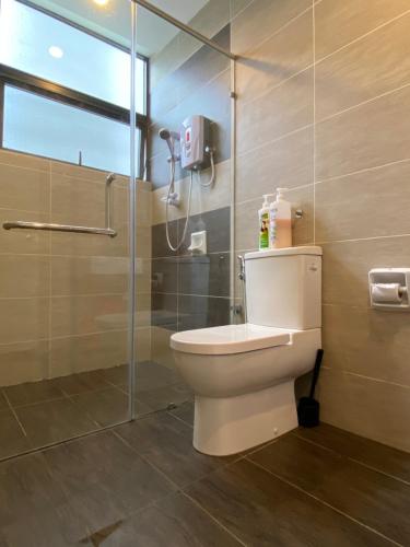 a bathroom with a toilet and a shower at The Lakes at Midhills Genting in Genting Highlands