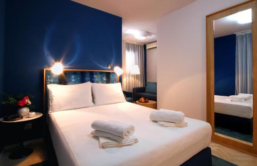 a hotel room with a bed with towels on it at Panonija in Kotor