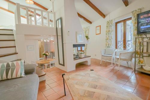 a living room with a couch and a fireplace at Duplex au coeur du vieil Antibes in Antibes