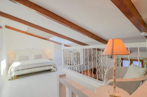 a bedroom with a bed and a desk with a lamp at Duplex au coeur du vieil Antibes in Antibes