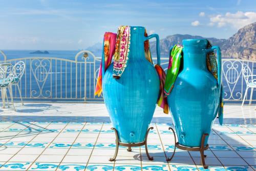 two vases sitting on chairs on a patio at Hotel Smeraldo in Praiano