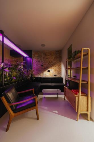 a living room with purple lighting and a couch at Owntown Apart Hotel in Kyiv