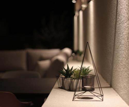 a table with two plants in a living room at Apartment KATE in Trogir