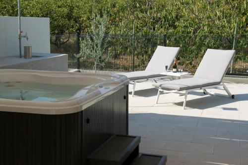 two chairs and a tub and two chairs on a patio at Apartment KATE in Trogir