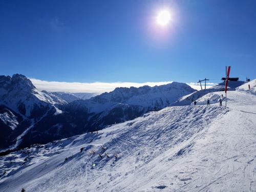 a group of people on a snow covered ski slope at Alpen Appartements Lärchenhof in Lermoos