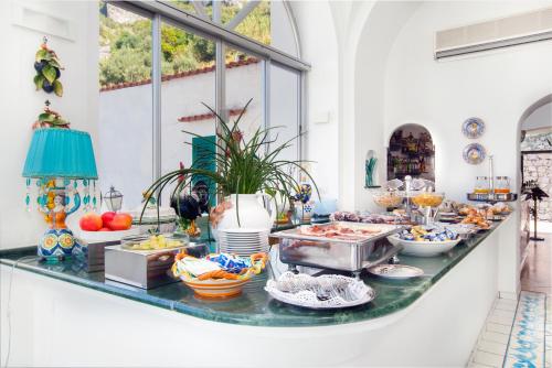 a buffet of food on a counter in a room at Hotel Smeraldo in Praiano