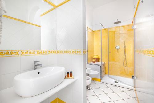 a bathroom with a sink and a shower and a toilet at Hotel Smeraldo in Praiano