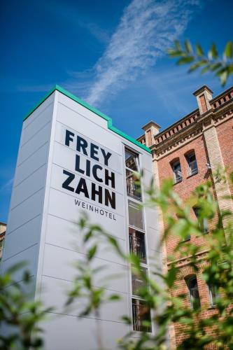 a sign on the side of a building at Weinhotel Freylich Zahn in Freyburg
