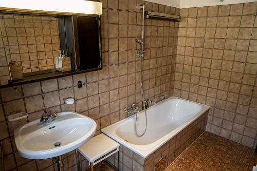 a bathroom with a sink and a bath tub at Apartment Hava in Bad Hofgastein