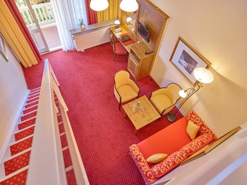 an overhead view of a living room with a couch and chairs at Parkhotel Bad Griesbach in Bad Griesbach