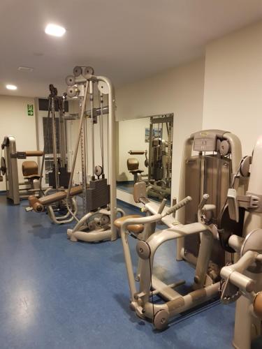 a gym with several treadmills and exercise machines at Graf's Apartment Sankt Englmar in Sankt Englmar