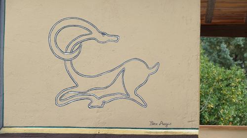 a drawing of a goat on the side of a wall at The old olive mill house in Aegae