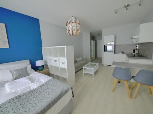 a bedroom with a bed and a table and a kitchen at Blue River Side in Blaustein