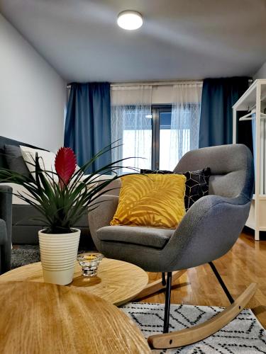 a living room with a chair and a table at Goreta032 Apartment in Vukovar