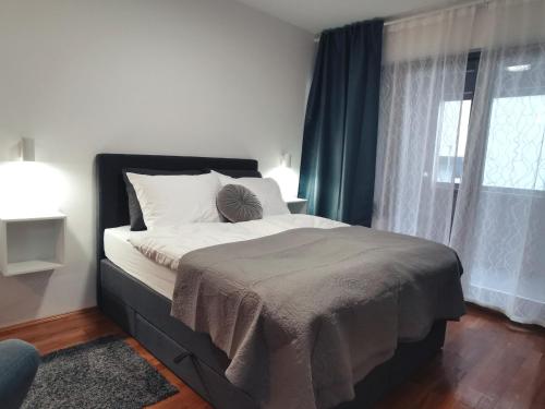 a bedroom with a bed and a window at Goreta032 Apartment in Vukovar