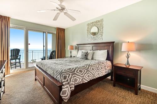 a bedroom with a bed and a balcony at Sterling Shores 807 Destin (Condo) in Destin
