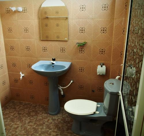 a bathroom with a toilet and a sink at Disna Place in Unawatuna