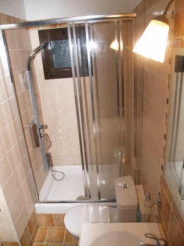 a bathroom with a shower and a toilet and a sink at Village Naiades in Kastoria