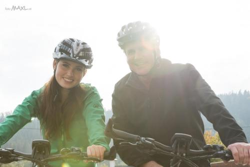 a man and a woman riding a bike at Hotel Angerer-Hof in Anger