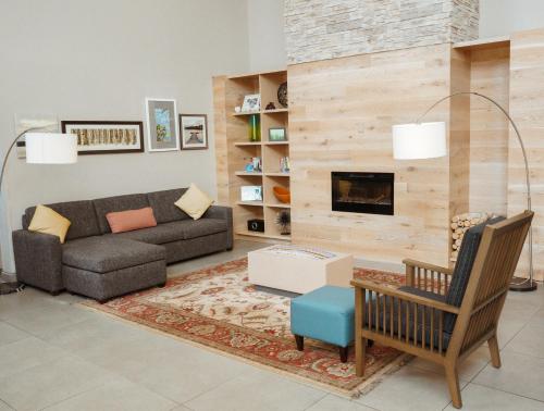 a living room with a couch and a fireplace at Country Inn & Suites by Radisson, Myrtle Beach, SC in Myrtle Beach