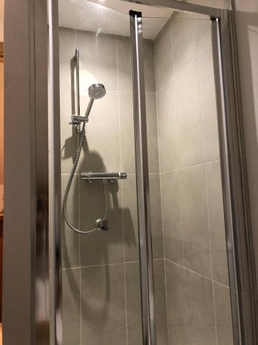 a shower in a bathroom with a glass door at quiet secluded loft in County Durham in Durham