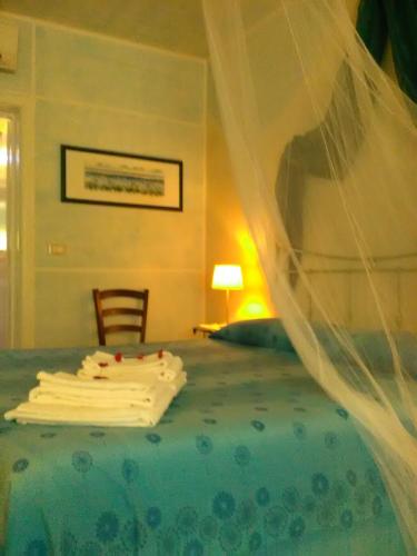 a bedroom with a bed with a veil over it at La Casa di Ulisse B&B in Quercianella