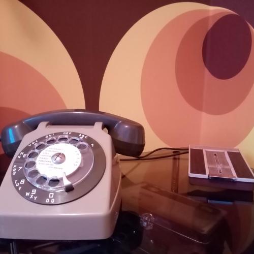 a close up of a telephone and a laptop at Gîte Version 70 in Mondrepuis