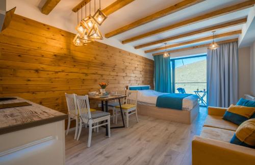 a bedroom with a bed and a table and chairs at NEW GUDAURI ATRIUM 336 in Gudauri
