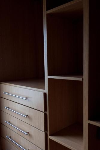 a closet with wooden shelves and drawers at Can Congost in Sort