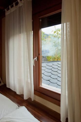 a bedroom with a window with a view of a mountain at Can Congost in Sort