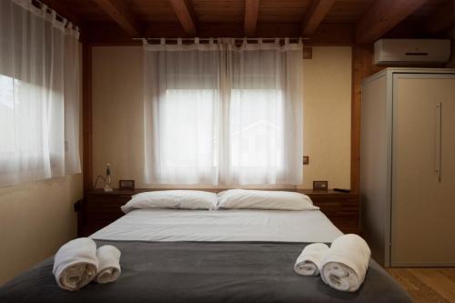 a bedroom with a large bed with towels on it at Can Congost in Sort