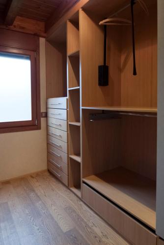 a closet with wooden shelves and a window at Can Congost in Sort