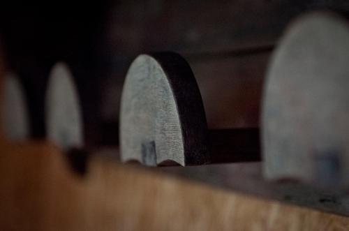 a group of knives sitting on a wooden shelf at Can Congost in Sort
