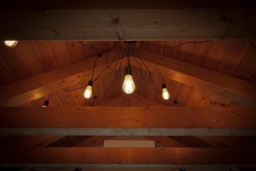a group of lights hanging from a wooden ceiling at Can Congost in Sort