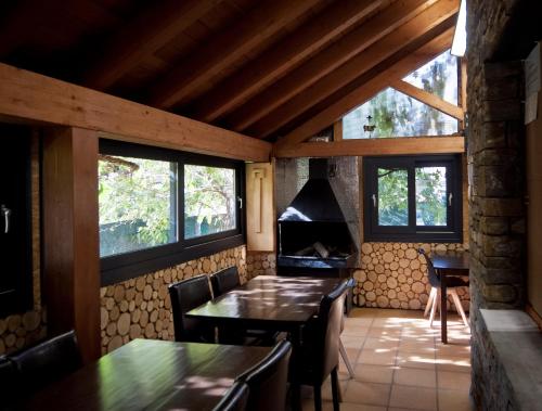 a dining room with a table and a stove at Can Congost in Sort
