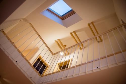 a staircase with a window and a skylight at House On The Hill (Hiška Na Griču) in Spodnja Idrija